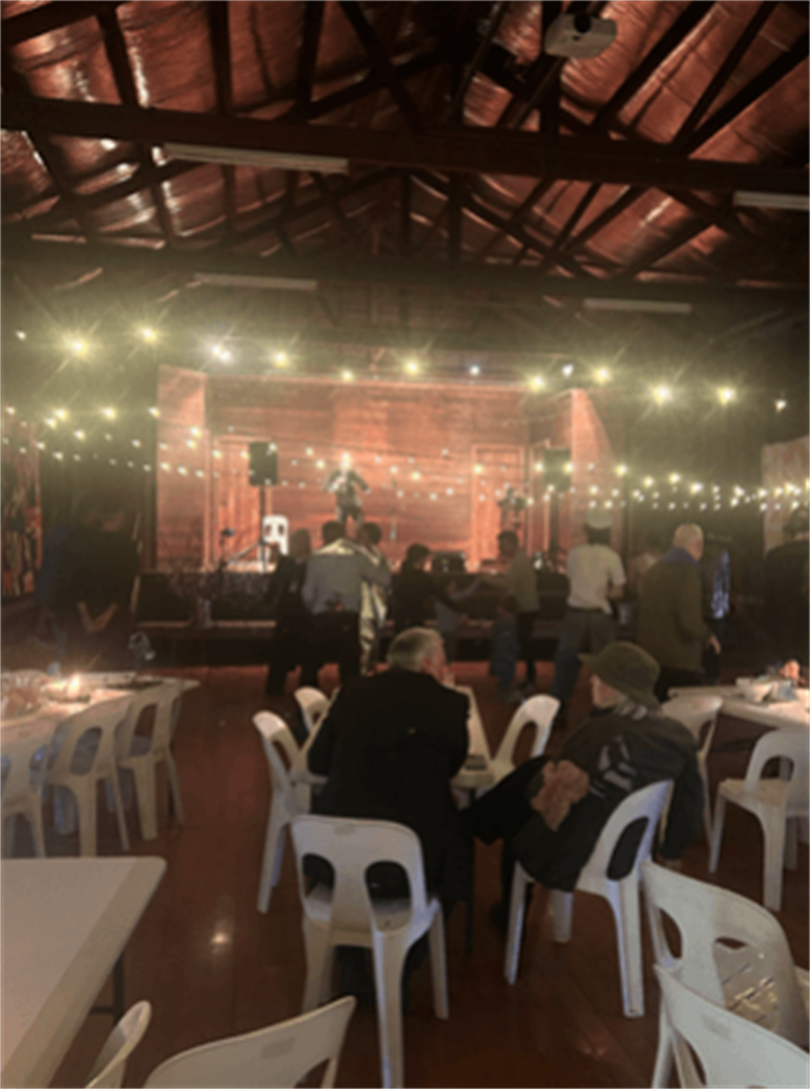 Community event inside the hall with festoon lighting