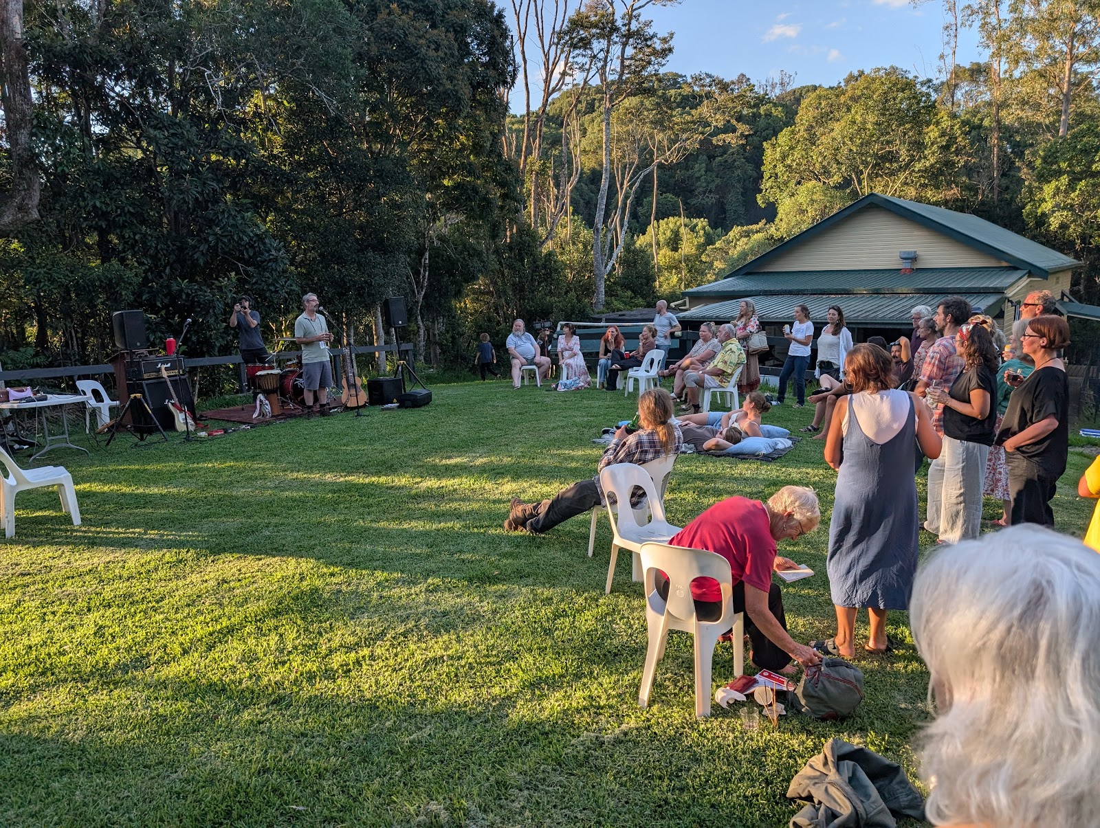 Community gathering on the hall lawn at golden hour