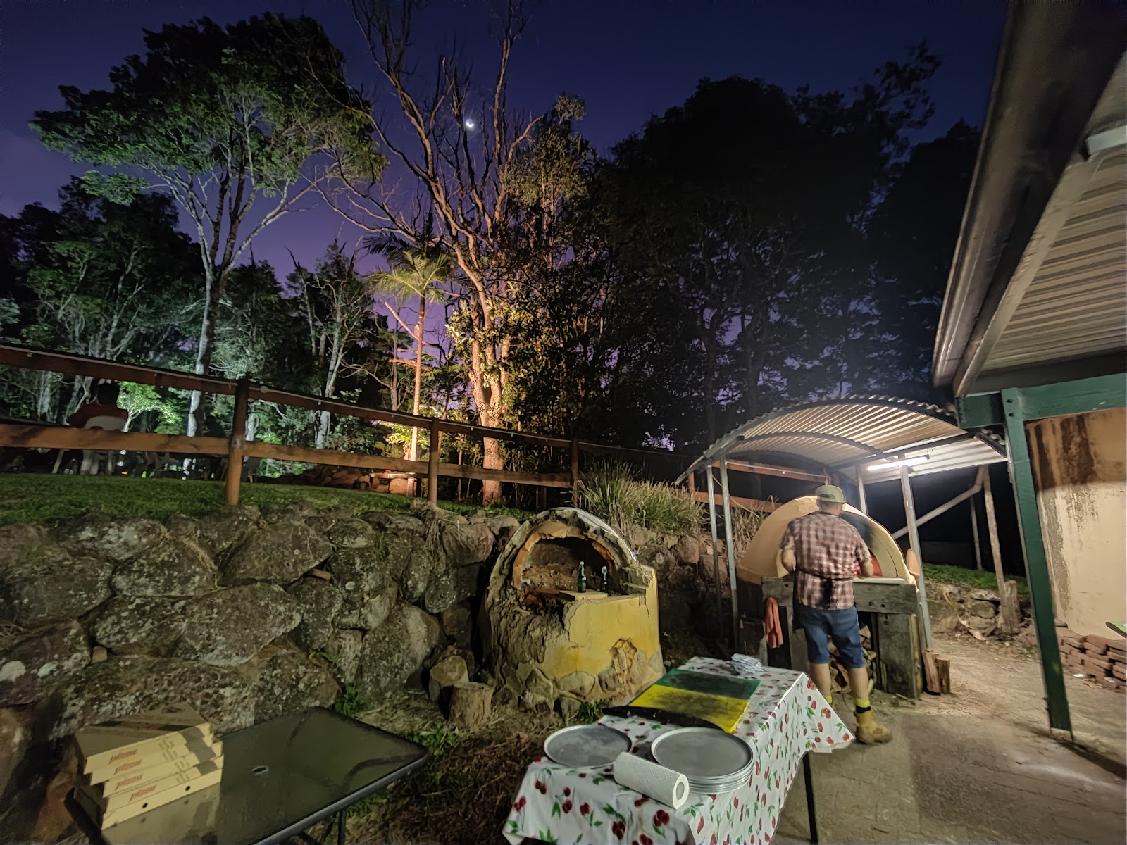 Pizza night setup with oven and prep tables at night