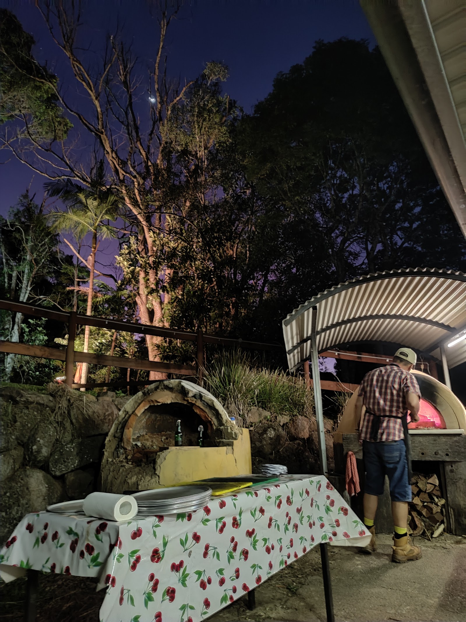 Wood-fired pizza oven glowing at twilight